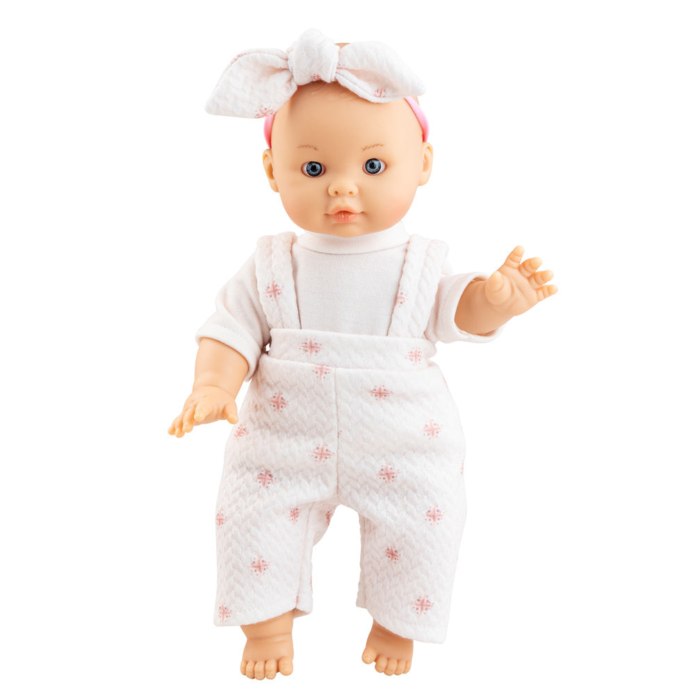 Die Puppe von Paola Reina hat blaue Augen und trägt ein rosafarbenes Puppenoutfit mit Schleife auf dem Kopf.
